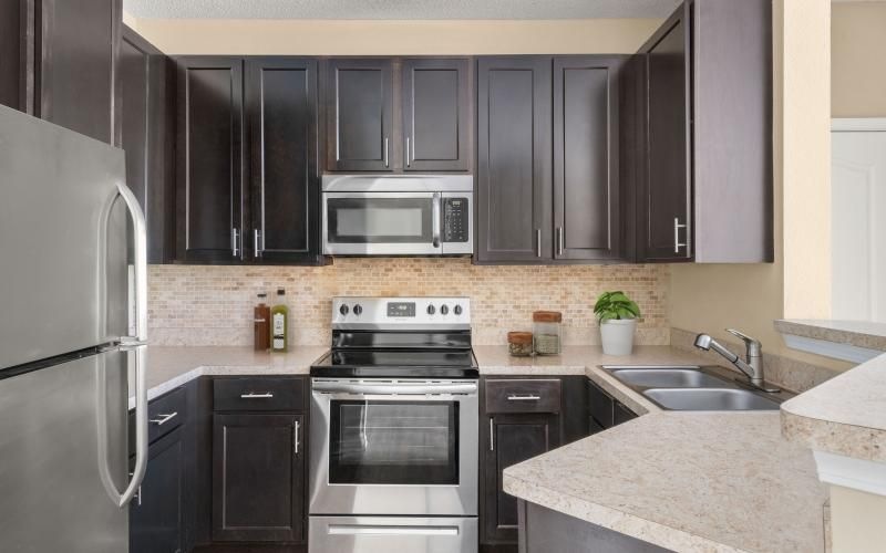 a kitchen with black cabinets