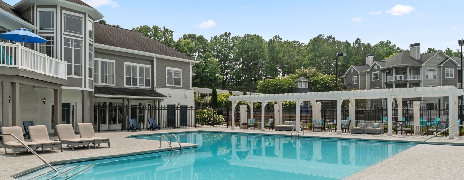 community swimming pool with apartment buildings in the background