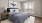 a bedroom with a bed and lamps